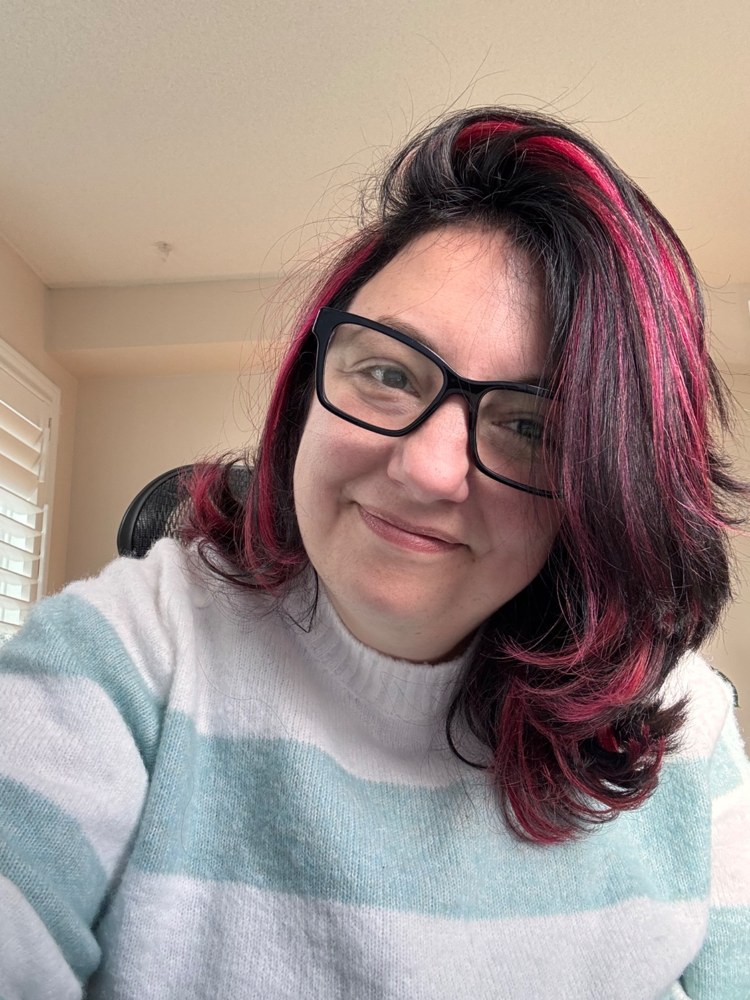 Pauline O’Brien wearing glasses and a mint and white striped sweater